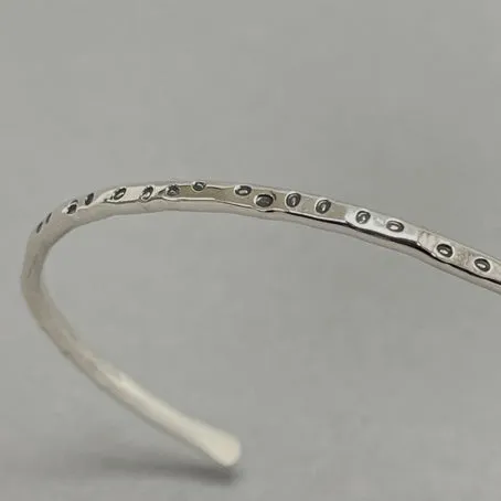 Open silver bangle - oval dots