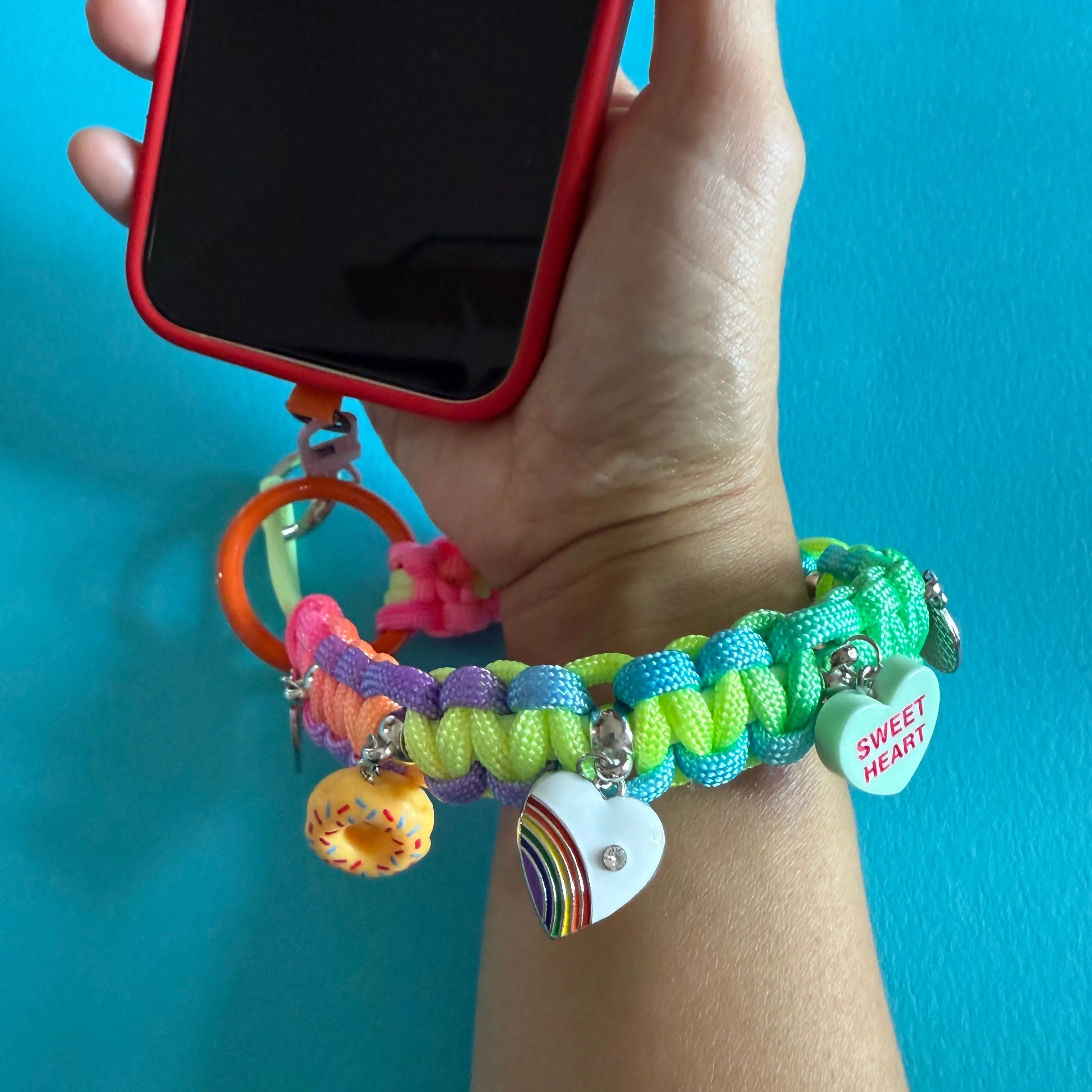 Phone wristler strap with charms